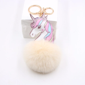Unicorn plush ball keychain with colorful gradient mane and cream faux fur charm