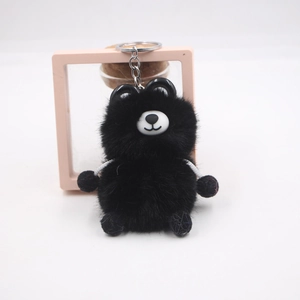 Detail view of a cute black plush bear keychain with soft texture and silver metal ring