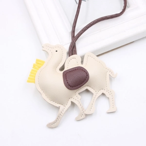 Minimalist beige PU leather camel bag charm with yellow tassel and brown strap detail