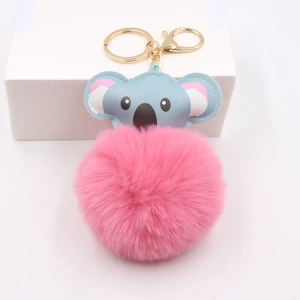 Detailed close-up of a pink plush koala keychain with golden metal ring and lobster clasp