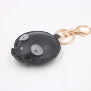 Creative black PU leather skull keychain charm with gold metal hardware and heart detail