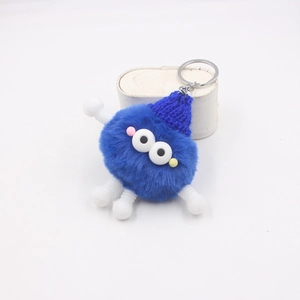 Détails du porte-clés monstre bleu en peluche avec bonnet en tricot et membres à ressorts