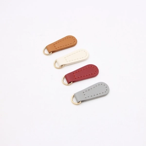 Close-up of DIY PU leather pendant charms with golden D-rings in four classic colors