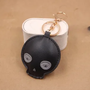 Close-up of black PU leather skull keychain with gold lobster clasp and X-stitch eyes