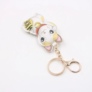 Cartoon lucky cat leather keychain with gold coins and metal clasp on white background