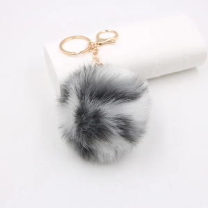 Plush faux rabbit fur keychain with black and white spotted ball and golden metal ring