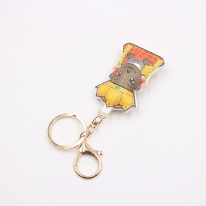 Detail of cartoon Buddha leather keychain with gold metal clasp and yellow monk robes