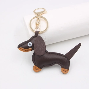 Close-up of brown PU leather dachshund dog keychain with golden lobster clasp and stitching
