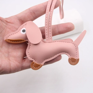 Pink leather dachshund charm with white contrast stitching and long strap for bags