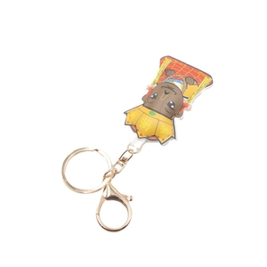 Cartoon Buddha leather keychain pendant with gold ring and red robe on white background