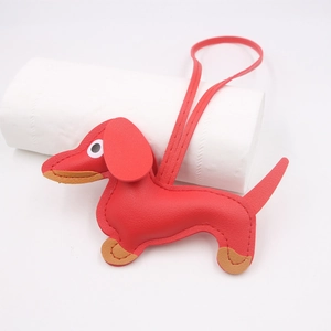 Detailed view of red leather dachshund dog keychain with litchi grain texture
