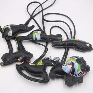Dark leather animal bag charms set featuring elephant and lion with abstract prints