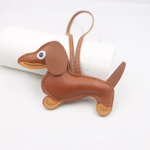 Brown leather dachshund dog keychain charm with stitching details and long hanging cord