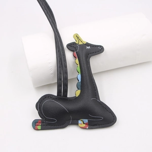 Artistic black leather animal keychain with colorful patchwork on white background