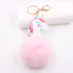 Pink unicorn pom pom keychain with gold lobster clasp and white faux leather charm