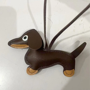 Detailed stitching and texture of brown leather dachshund dog keychain charm with lanyard