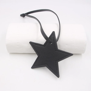 Close-up of black PU leather star pendant with fine stitching and long matching lanyard