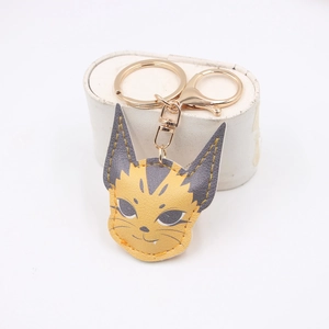 Detail of cute leather caracal keychain with golden metal ring and lobster clasp