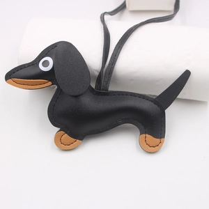 Detail view of the hand-stitched faux leather dachshund pendant with a long black lanyard