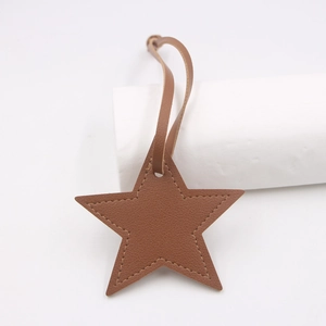 Star-shaped brown PU leather charm with fine stitching and matching lanyard for bags