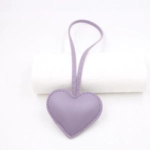 Detail of lavender PU leather heart bag charm with matching top loop and stitching