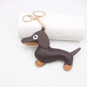 Macro detail of dachshund leather keychain showing fine stitching and gold hardware