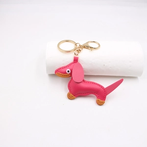 Detailed close-up of pink PU leather dachshund keychain with gold-polished hardware