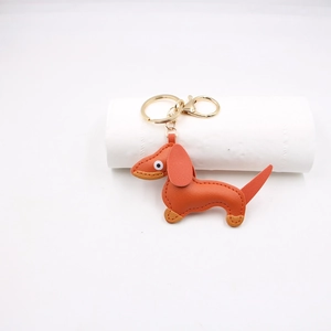 Detail of orange PU leather dachshund keychain with golden ring and lobster clasp