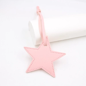 Close-up of pink star-shaped PU leather bag charm with neat edge stitching details