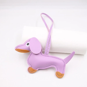 Detail of purple litchi grain leather dachshund charm with stitching and lanyard