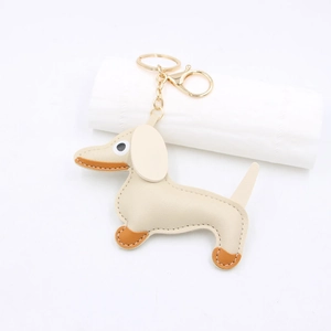 Close-up of a handmade leather dachshund dog keychain with elegant golden hardware