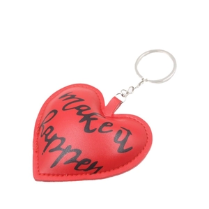 Red PU leather heart-shaped keychain with silver metal ring and 'make it happen' text