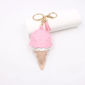 Detailed close-up of pink and white leather ice cream keychain with gold ring and tassel