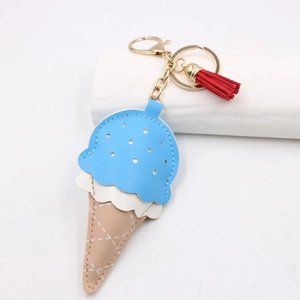 Detail of leather ice cream keychain with blue and pink panels and a red tassel