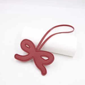Dark red faux leather bow charm with edge stitching for bags and keyrings