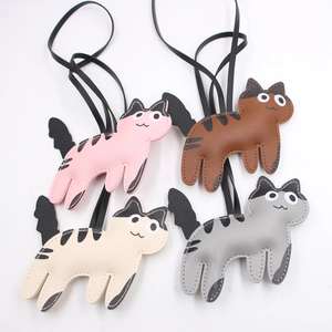 Set of four cute cartoon leather cat bag charms in pink, brown, beige, and grey colors