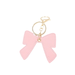 Pink PU leather bow keychain with white stitching and gold lobster clasp on white background