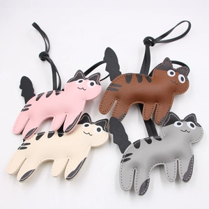 Detailed view of four colorful PU leather cat charms with stitch edges and black straps