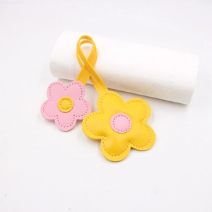 Floral leather charm with yellow and pink flower petals and precise stitching detail