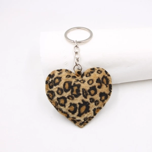 Close-up of heart-shaped leopard print plush keychain with silver metal ring and chain