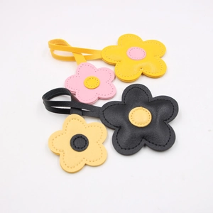Detail of colorful PU leather cherry blossom flower pendants with neat stitching