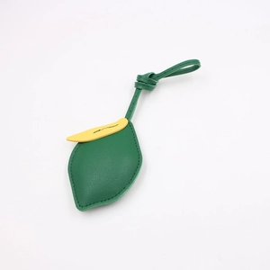 Detail eines grünen Blatt-Taschenanhängers aus PU-Leder mit Lychee-Narbung und Gelb