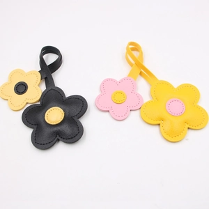 Fresh cherry blossom leather bag charms in black, yellow, and pink colors