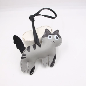 Close-up of cute grey faux leather cat bag charm showing detailed stitching and strap