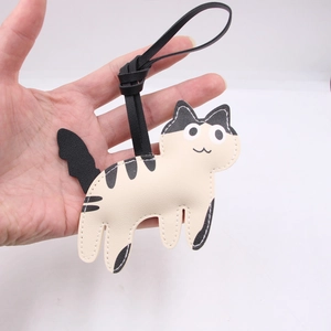Detail of cute cow cat PU leather bag charm with high-quality stitching and texture