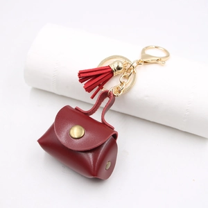 Portachiavi Mini Borsellino in Pelle PU Rétro per Donna Ciondolo Piccola Borsa a Mano Rosso Vino Con Nappa e Anello Dorato