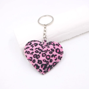 Detailed view of pink leopard print plush heart keychain with silver metal ring