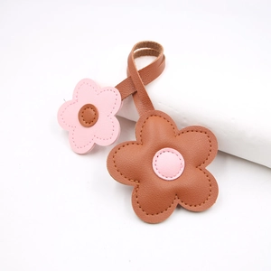 Pink and brown leather flower keychain charm with stitched petals for handbags