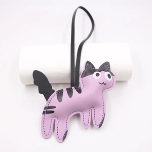 Detail view of purple leather cat charm with black stripes and white stitched edges