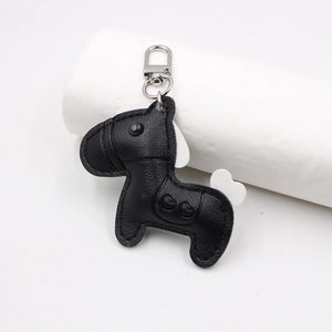 Close-up of black lychee grain leather horse charm with heart patterns and metal clasp